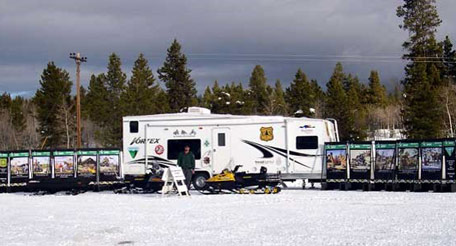 Snowmobiler riding along marked path