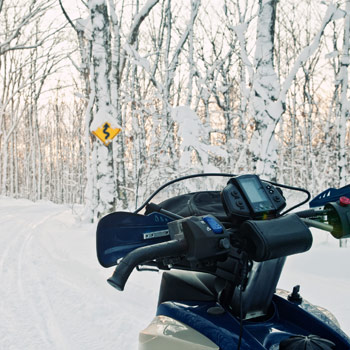 Snowmobiler approaching trail